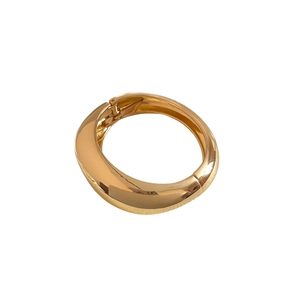 Elegant gold irregular geometric bangle featuring a high-polished metallic mirror finish