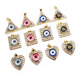 Macro shot of 12-piece copper zircon evil eye pendants in heart and geometric shapes