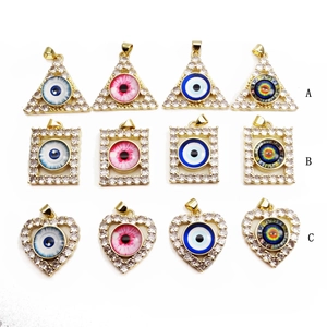 Golden evil eye pendants with cubic zirconia inlay in heart, triangle, and rectangle shapes