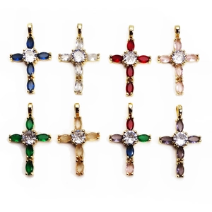 Detailed view of copper cross pendants with multi-color zircon marquise stones