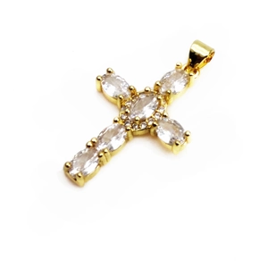 Détail d'un pendentif croix doré orné de zircons de taille marquise et ronde scintillants