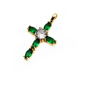 Detail of cross pendant with golden base, marquise green gems and white zircon center