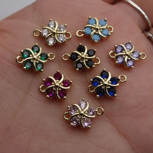 Eight colors of micro-pave zircon flower connectors for DIY jewelry making in palm