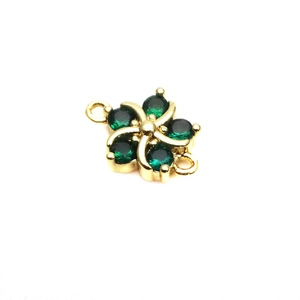 Macro shot of 10mm gold flower jewelry connector with green cubic zirconia petals