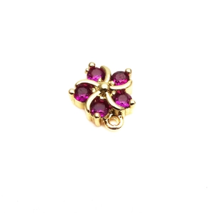 Detailed close-up of a 10mm gold flower connector with micro-set magenta zircon for DIY jewelry