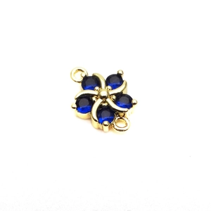 Detail of flower connector with dark blue gemstones and gold loops for DIY jewelry