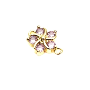 Detail of 10mm flower connector with pink zircons and gold plating for DIY bracelets