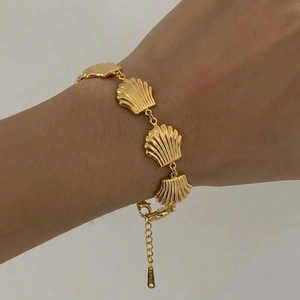 Elegant gold-tone stainless steel bracelet featuring delicate shell charms with lobster clasp