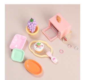 Macro view of colorful miniature resin kitchen toys and dollhouse play food accessories