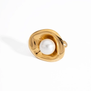 Primer plano detallado de un anillo de acero inoxidable dorado con cuenco irregular y perla.