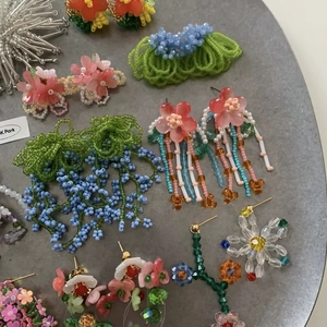 Detailed view of colorful beaded tassel flower earrings for a sweet forest style look.