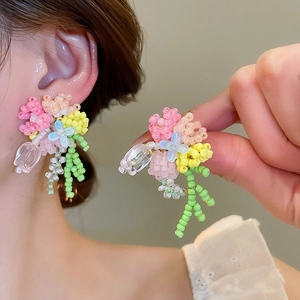 Detailed view of colorful beaded floral waterfall stud earrings in sweet forest style
