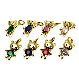 Macro shot of bear charms with colorful zircons in gold-plated alloy for jewelry making