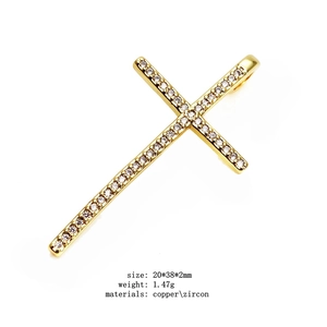 Detailed close-up of a gold-plated copper cross pendant with micro-pave white zircon stones
