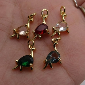 Five colorful dinosaur jewelry pendants with pear-cut gemstones and gold-plated frames