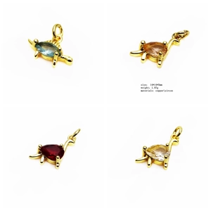 Macro detail of dinosaur charms made of copper and zircon in multiple colors