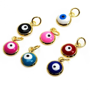 Flat lay of colorful evil eye enamel pendants with gold plating for jewelry making