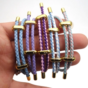 Macro shot of colorful 3mm braided cords with adjustable gold D-buckles and metal ends