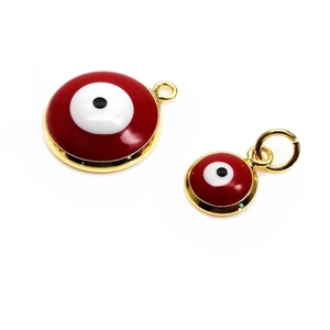 Detail of red and white evil eye charms in two sizes with gold metal edges for jewelry making
