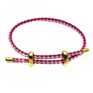Detail of hand-woven pink and purple 3mm cord bracelet with adjustable gold slide buckles