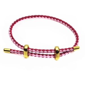 Detail of 3mm woven cord bracelet in pink and purple with gold adjustable sliders