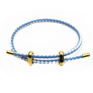 Detail of blue and white braided rope bracelet with adjustable gold-plated metal cylinders