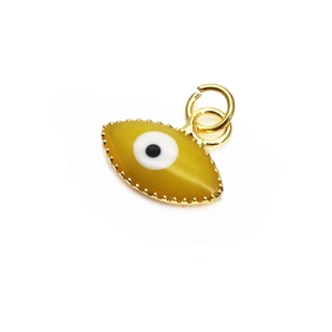 Macro view of 10mm yellow evil eye pendant with gold gear edge and jumping ring