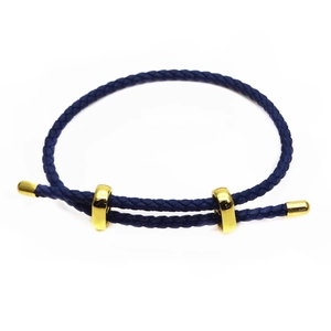 Detail of blue braided bracelet with adjustable golden slider beads and 3mm thickness