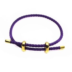 Detail of purple braided bracelet with adjustable golden metal sliding buckles on white background