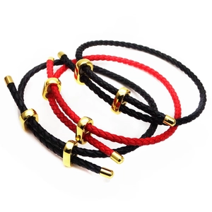 Detail view of 3mm braided leather cord bracelets with adjustable gold metal sliders