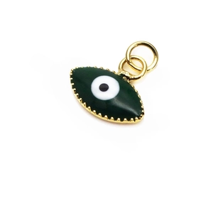 Detail of green enamel evil eye charm with gold serrated edge and dual jump rings