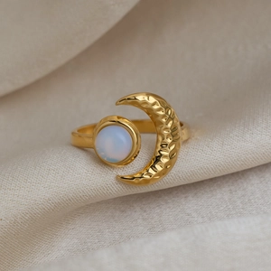 Detailed view of 18K gold plated ring with hammered crescent moon and round opal