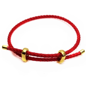 Close-up of red braided 3mm cord bracelet with adjustable golden square sliders