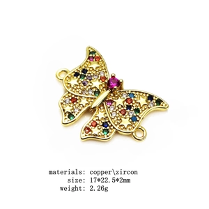 Macro detail of colorful zircon butterfly connector for DIY jewelry making in gold plated copper