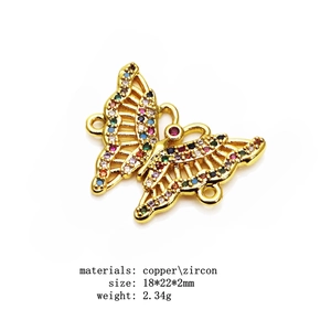 Macro detail of a 18x22mm gold copper butterfly connector with multicolor cubic zirconia