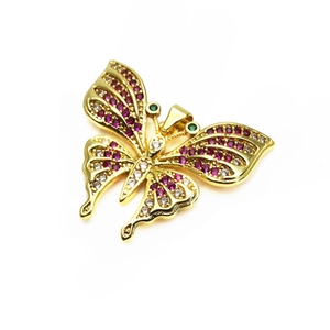 Detailed macro shot of vintage butterfly pendant with red, green and white zircon stones