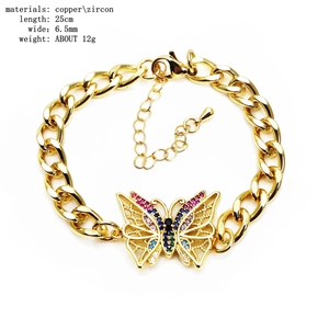 Macro shot of colorful zircon butterfly connector and golden copper chain jewelry detail
