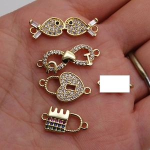 Gold-plated connectors featuring heart, fish, and infinity designs with cubic zirconia