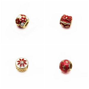 Macro detail of red enamel lucky cat and floral gold beads for DIY jewelry making