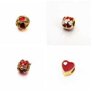 Detail view of gold-plated lucky cat and red enamel heart charms for DIY jewelry making