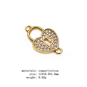 Macro detail of copper heart lock connector with pave zircons and precise measurements