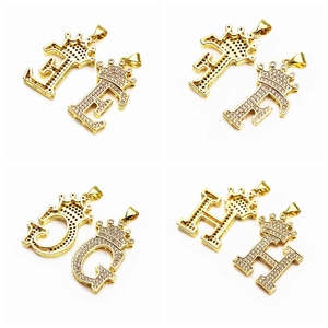 Macro view of gold plated crown initial pendants with micro-pave cubic zirconia crystals