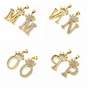 Macro shot of gold-plated crown alphabet pendants M N O P with micro-pave zircons
