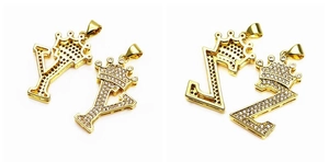 Detail view of hip-hop crown pendants with micro-paved cubic zirconia in gold plating