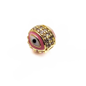 Macro detail of 14K gold evil eye bead with pink enamel and sparkling zircon pave