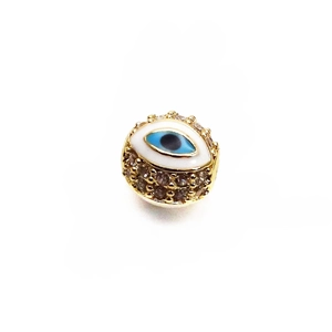 Macro detail of 14K gold-plated Evil Eye bead with sparkling pavé crystals for DIY jewelry