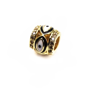 Macro detail of gold-plated evil eye charm with enamel filling and sparkling rhinestones