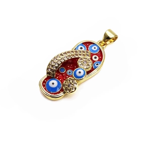 Macro shot of 14K gold-plated red enamel flip-flop pendant with evil eye and zircons