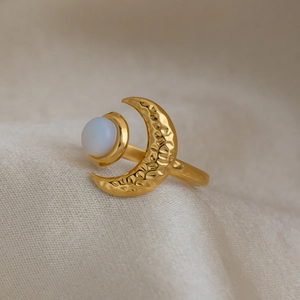 Close-up of elegant 18K gold plated stainless steel crescent moon ring with opal bead