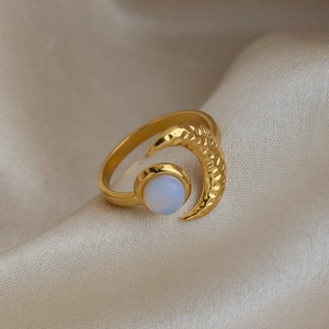 Close-up detail of a 18K gold plated stainless steel crescent moon ring with opal stone